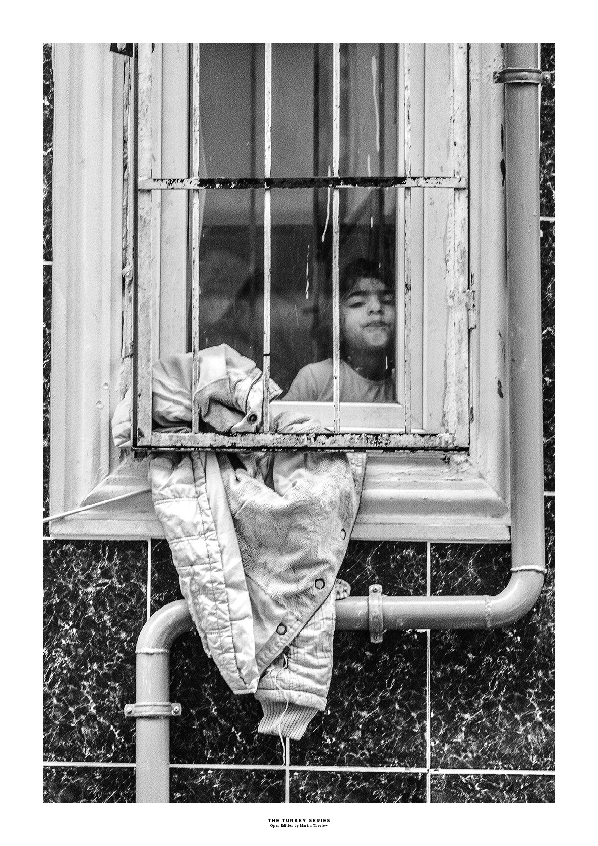 The Turkey Series - A Syrian girl in a window in Al Fatih, Istanbul. Photo by photographer Martin Thaulow. Open Edition (seen with the white frame around the image as it is sold). Buy high quality print.
